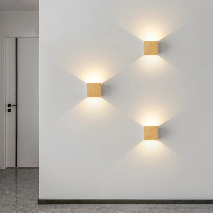 Modern decorative lamp trio on a wall, showcasing sleek design and warm ambient lighting.