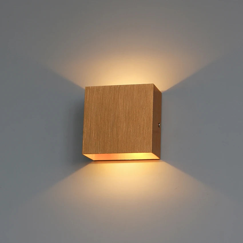 Modern wooden wall lamp with sleek design, casting warm ambient light, perfect for contemporary decor.