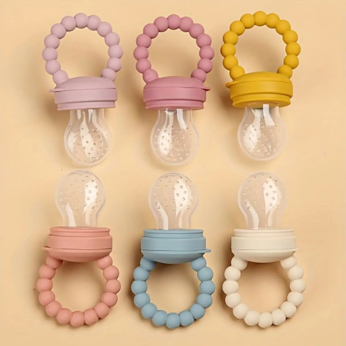 Set of colorful silicone fruit feeder pacifiers for babies, designed for soothing gums and self-feeding.